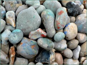 Paint on pebbles at the beach