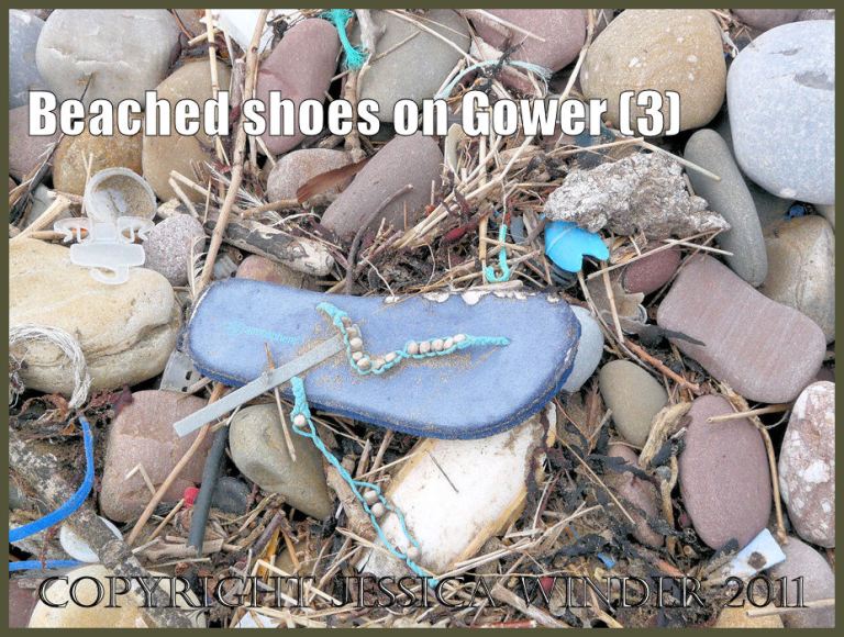 P1070744aBlog03 Ladies right pale blue flip flop sandal with beaded strap as flotsam on seashore pebbles (3)