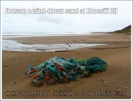 Flotsam fishing nets on Rhossili Beach: Flotsam fishing nets and ropes on the sandy beach at Rhossili, Gower, South Wales, UK (5)