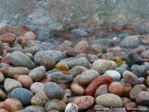 Wet pebbles at the water's edge in Pleasant Bay, Cape Breton Island, NS.