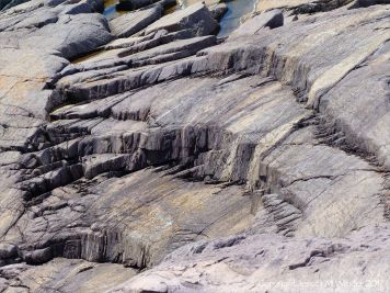 Rocks composed of volcanic ash (tuff) near Louisbourg Lighthouse in cape Breton, Nova Scotia.