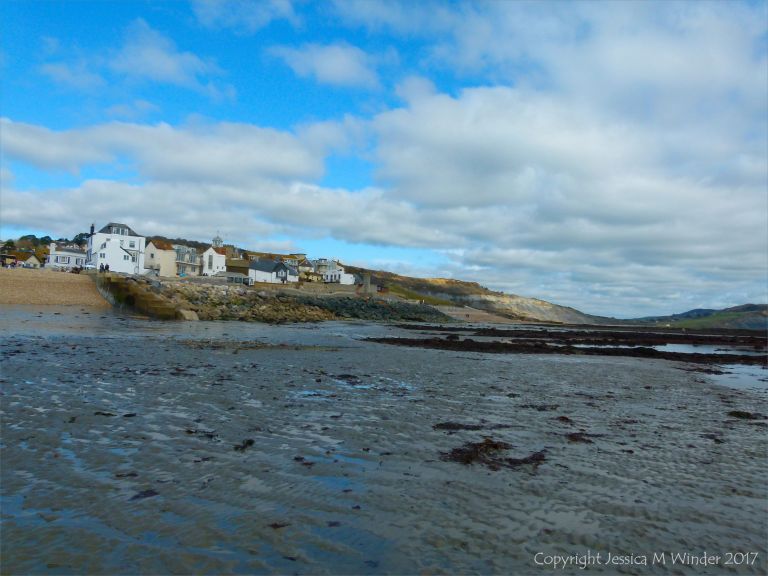 Low-tide expanse of sandy shore at Lyme Regis in Dorset, UK.