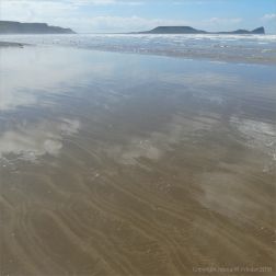 The sandy beach at low tide on Rhossili Bay