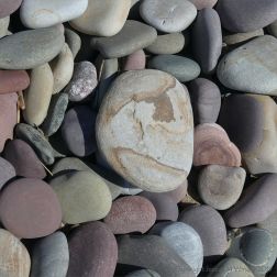 Pastel coloured dry pebbles on the beach