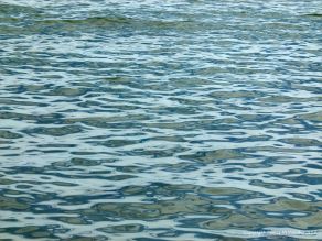 Natural patterns of reflected light on the surface of calm sea water