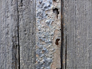 Textures produced by weathering and age on old boathouse woodwork and ironwork