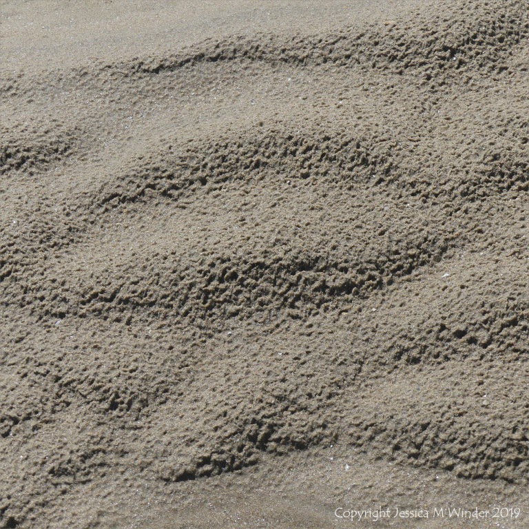 Natural sand patterns left by the ebbing tide