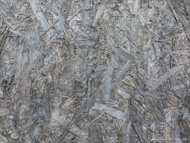 Close-up photograph showing texture in weathered chipboard