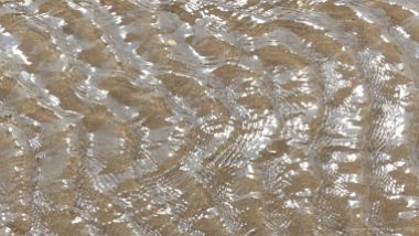 Rippled water of a beach stream at Swansea Bay