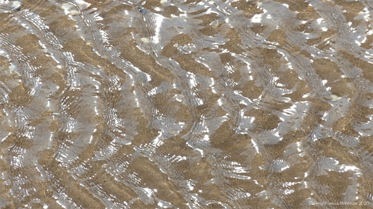 Patterns of reflected light on the surface of rippled water