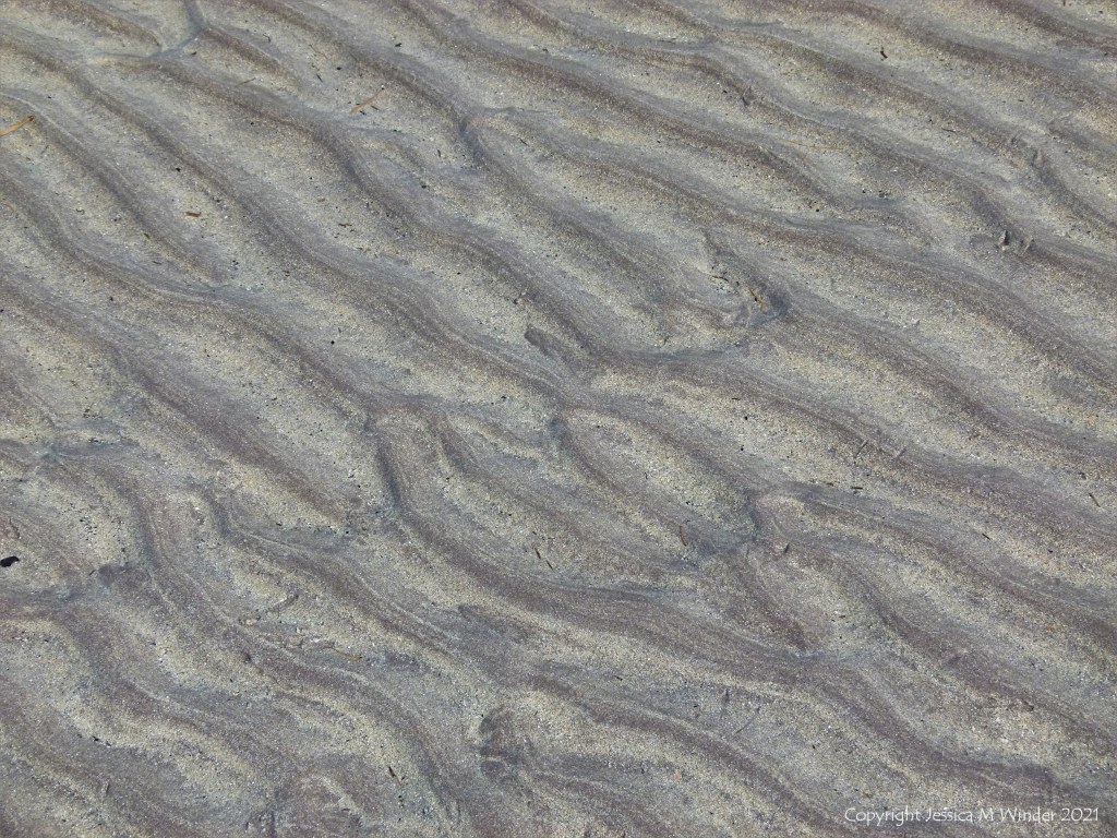 Natural sand ripples left by the tide on the beach