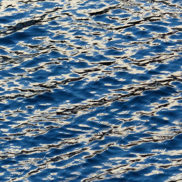 Detail of sea water pattern, texture, and light reflection