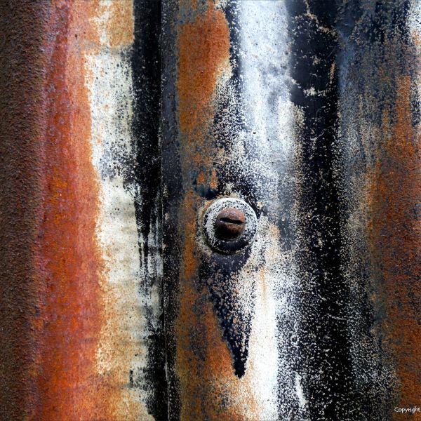 Detail of rust texture and patterns with old paint on corrugated iron
